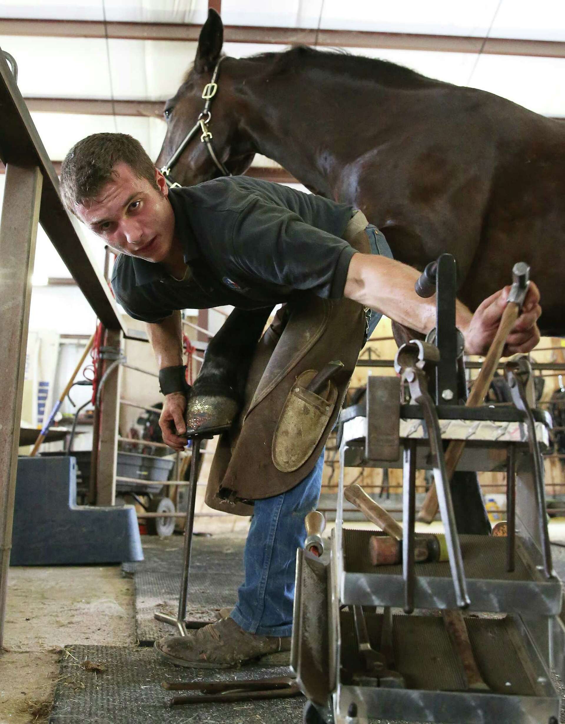 Young farrier carries on the ancient art of horseshoeing