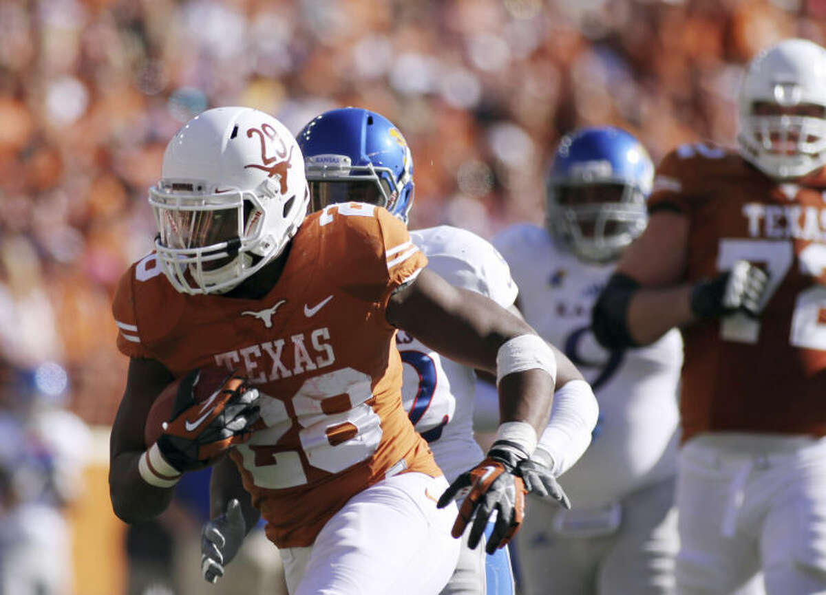 Texas' Malcolm Brown runs with the ball against Kansas during an NCAA college football game Saturday, Nov. 2, 2013, in Austin, Texas. Texas won 35-13. (AP Photo/The Daily Texan, Shelby Tauber)