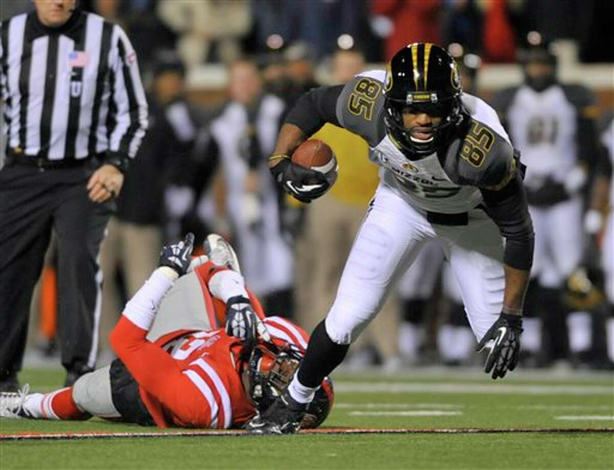Missouri receiver Marcus Lucas (85) avoids being tackled by Mississippi defensive back Tony Conner (12) during the first quarter of an NCAA college football game on Saturday, Nov. 23, 2013, in Oxford, MS. #8 Missouri beat #24 Mississippi 24-10. (AP Photo/ The Daily Mississippian, Austin McAfee)