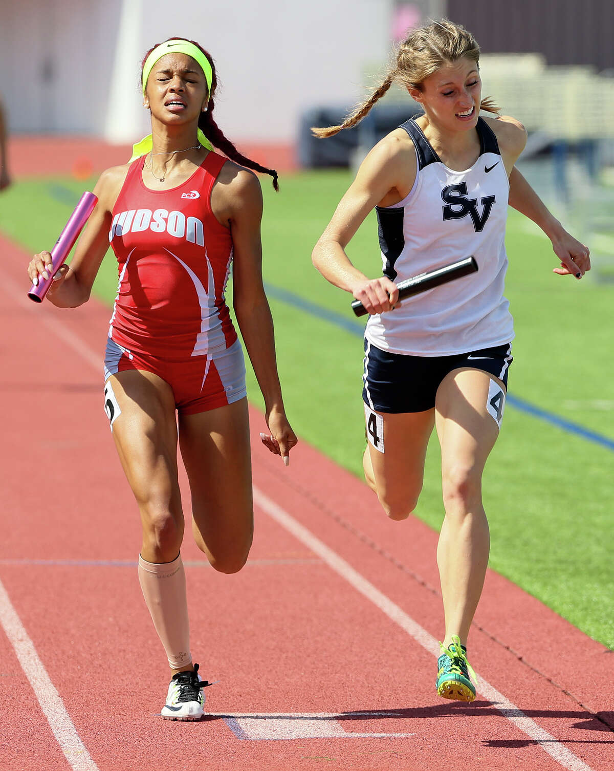 Judson’s Mariah Kuykendoll (left) battles Smithson Valley’s Reagan Bachman to the finish line of the 6A girls 1,600-meter relay during the finals of the Region IV-6A/5A track and field championships at Alamo Stadium on April 30, 2016.
