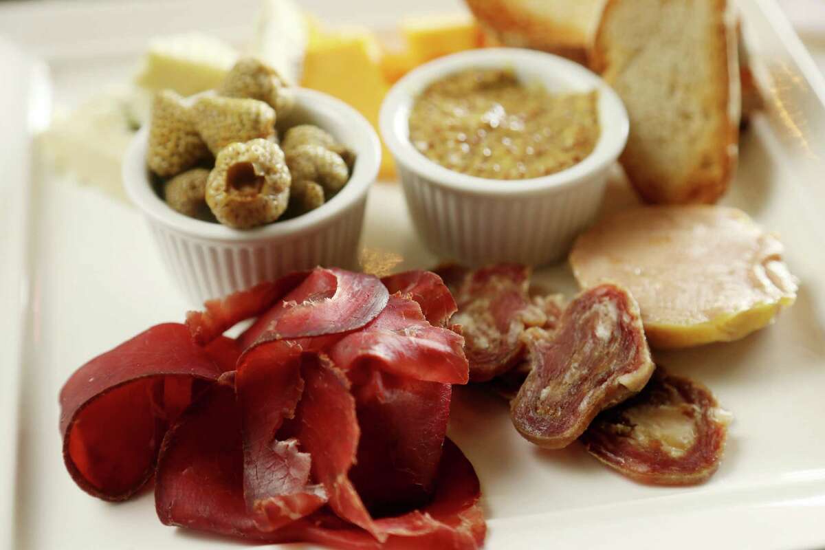 Charcuterie and cheese; a selection of Houston Dairymade cheese and cured meat with pickled vegetables, mustard and bread, at Harold's Tap Room.