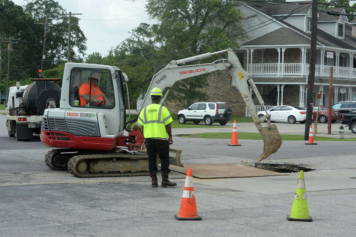 City employees cover a sinkhole from view Wednesday on Calder near Arlington Drive. The hole formed earlier that morning. Area business man Glen Johnson said this was the second sinkhole in the area in less than two weeks. Photo taken Wednesday, May 11, 2016 Guiseppe Barranco/The Enterprise