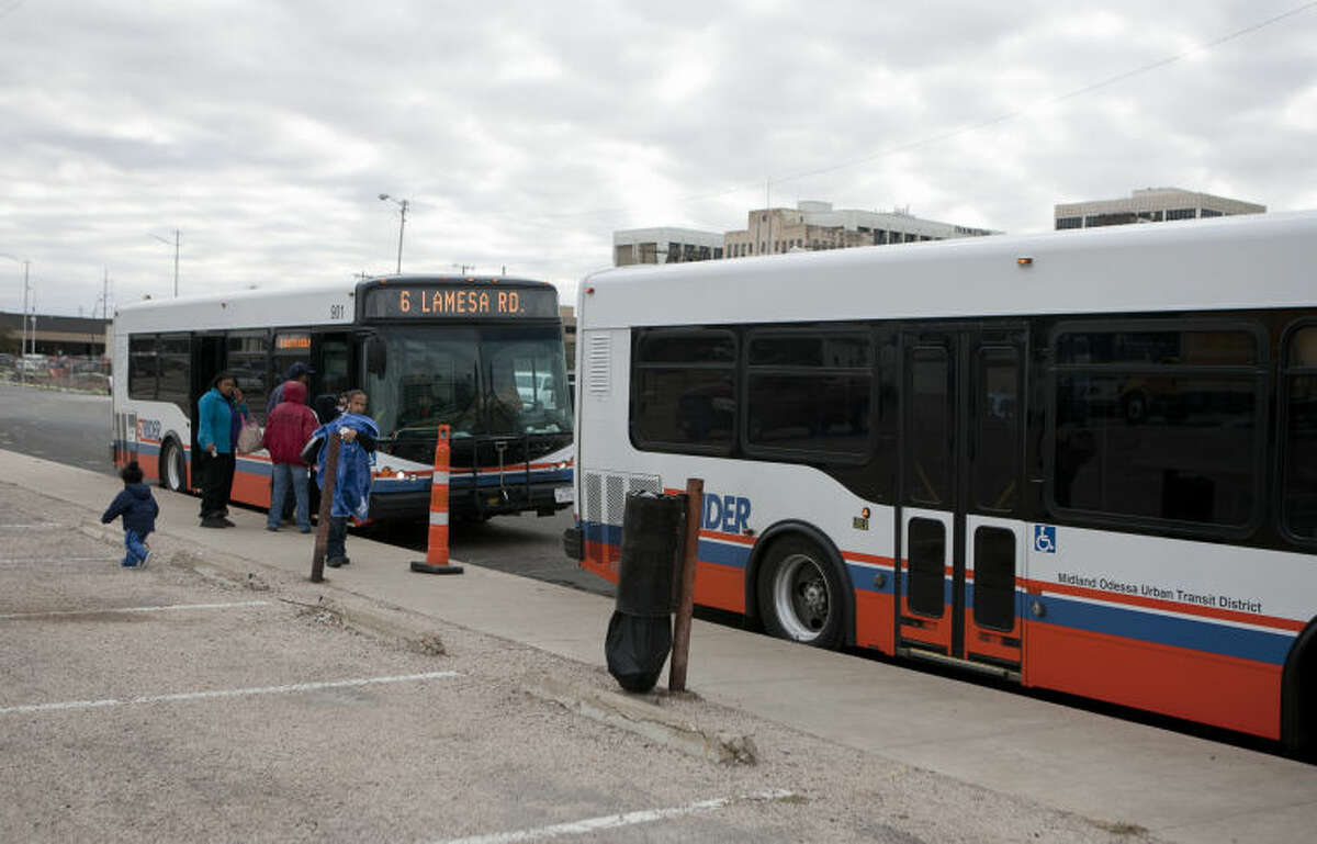 EZ Rider patrons wait change busses Tuesday at the temporary station on the east side of Baird Street. James Durbin/Reporter-Telegram
