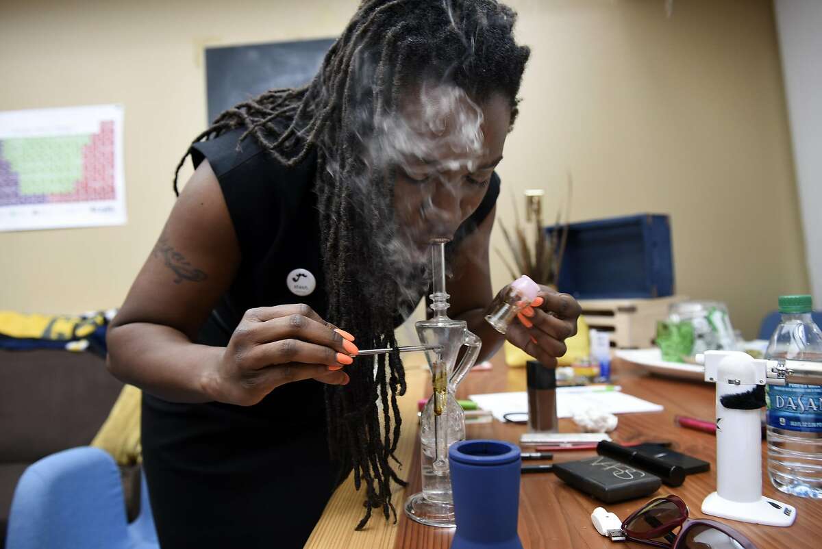 Andrea Unsworth, owner of the cannabis delivery service StashTwist, dabs a hit of live resin at her company's office in Berkeley, CA on May 11th, 2016.