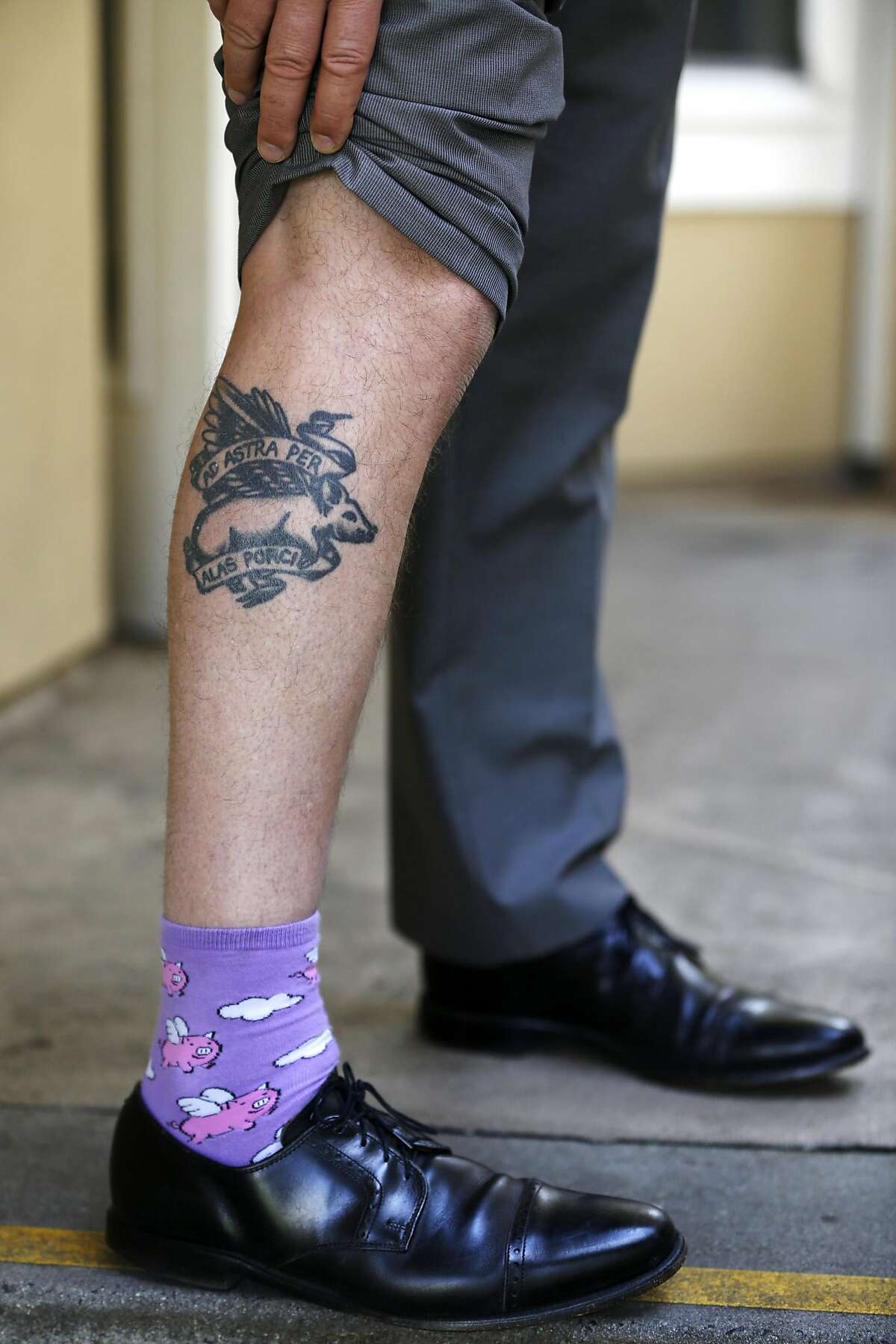 Jeff Kositsky, director of the new Department of Homelessness and Supportive Housing, shows off his flying pig socks and tattoo, which reads "to the stars on the wings of a pig," in San Francisco, California, on Wednesday, May 11, 2016.