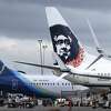 FILE - In this Monday, April 4, 2016, file photo, Alaska Airlines planes with the company's new livery and tail logo, left, and the old livery used to promote service to Hawaii, right, are shown parked at Seattle-Tacoma International Airport in Seattle. Alaska Airlines and JetBlue Airways still rank highest in the annual J.D. Power survey of passengers on the nine largest North American airlines, and the firm says overall traveler satisfaction with the industry is at a 10-year high. J.D. Power said Wednesday, May 11, 2016, that Alaska ranked highest among traditional airlines for the ninth straight year and JetBlue was the top-rated low-cost carrier for the 11th year in a row. (AP Photo/Ted S. Warren, File)