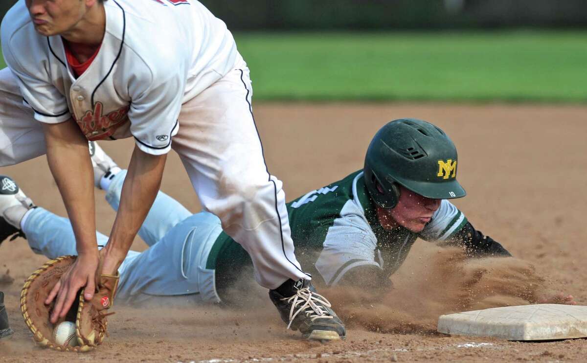 New Milford's Riley Zimmerman (4) dives back to first to beat the throw to Pomperaug first baseman Grant Wallace (29) from the catcher in the boys baseball game between New Milford and Pomperaug high schools, on Wednesday, May 11, 2016, at Pomperaug High School, Southbury, Conn.