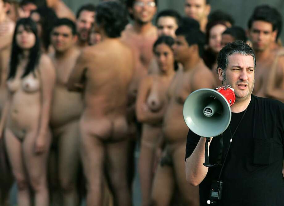 Photographer Spencer Tunick gives instructions to volunteer participants to...