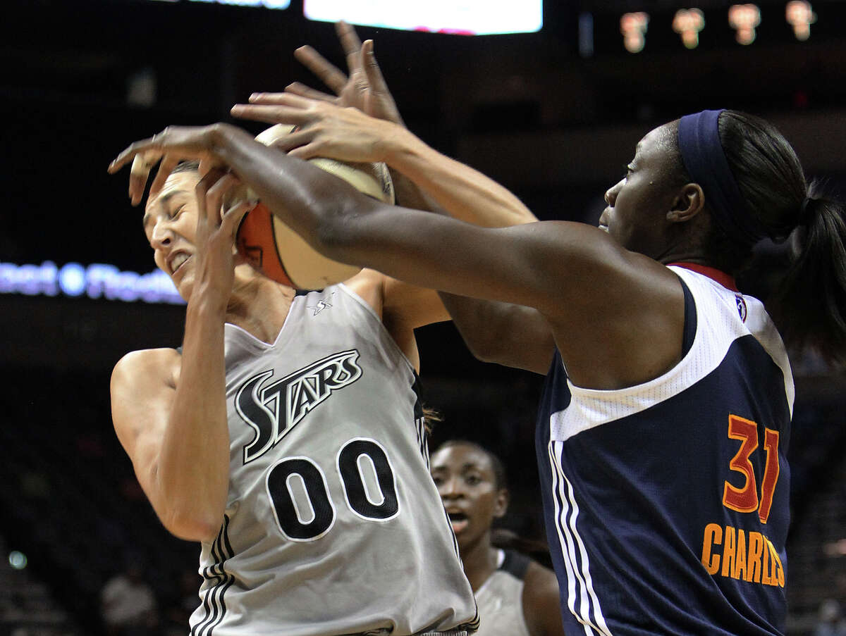Silver Stars’ Ruth Riley (let) gets tangled up with Connecticut’s Tina Charles during a rebound in the first half at the AT&T Center on Aug. 30, 2011.