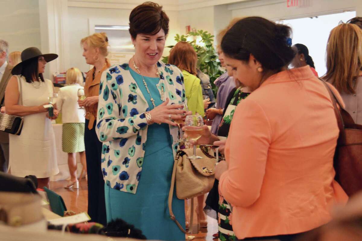 Eilish Hourihan, with Stamford Hospital, converses at the Old Bags Luncheon in Greenwich, Conn. on Thursday, May 12, 2016. All proceeds from the event's bag auctions will help fund the Greenwich YWCA Domestic Abuse Services.