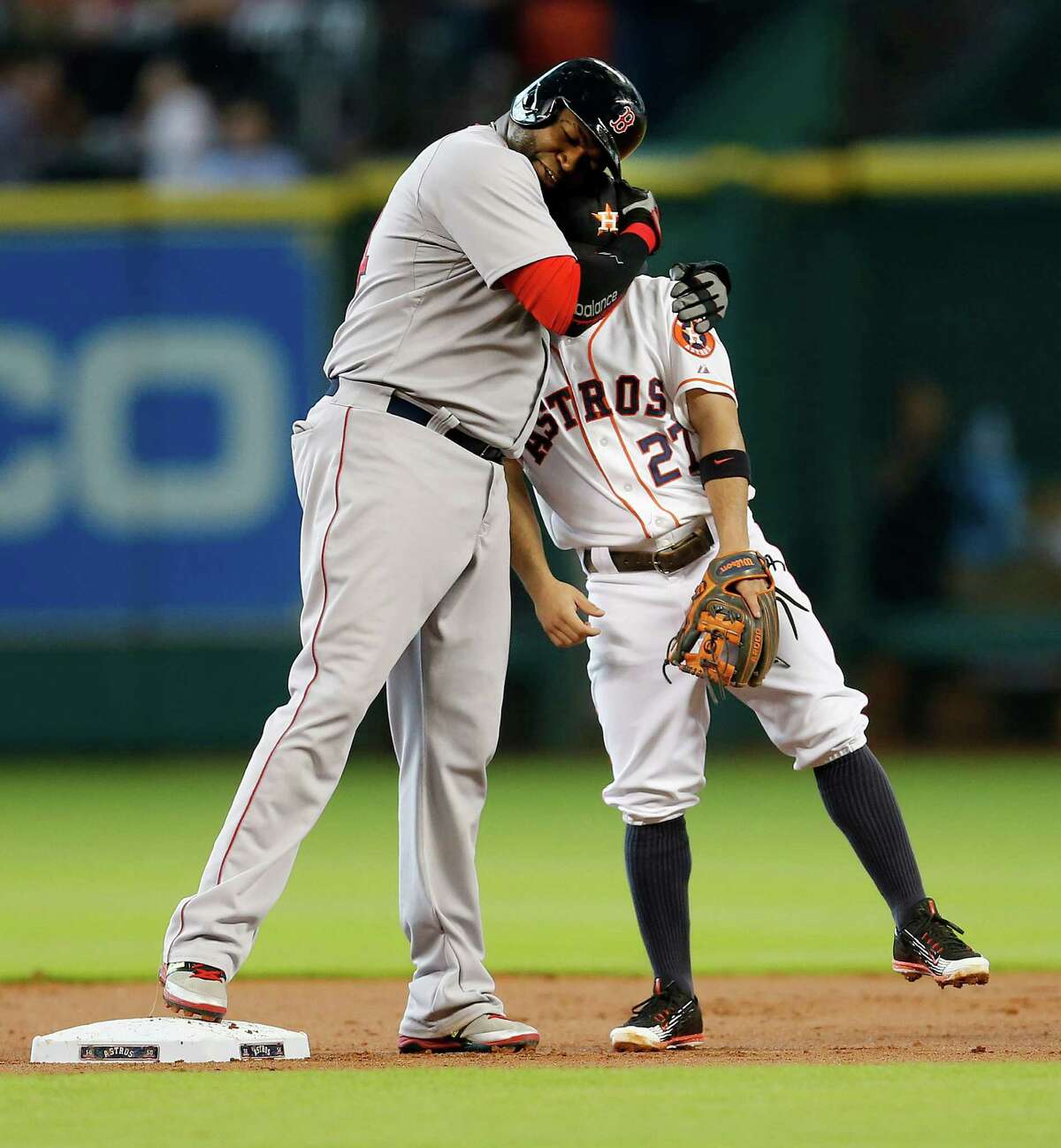 Boston Red Sox designated hitter David Ortiz (34) hugs Houston Astros second baseman Jose Altuve (27) after Ortiz's double during the first inning of an MLB game at Minute Maid Park on Thursday, July 23, 2015, in Houston.