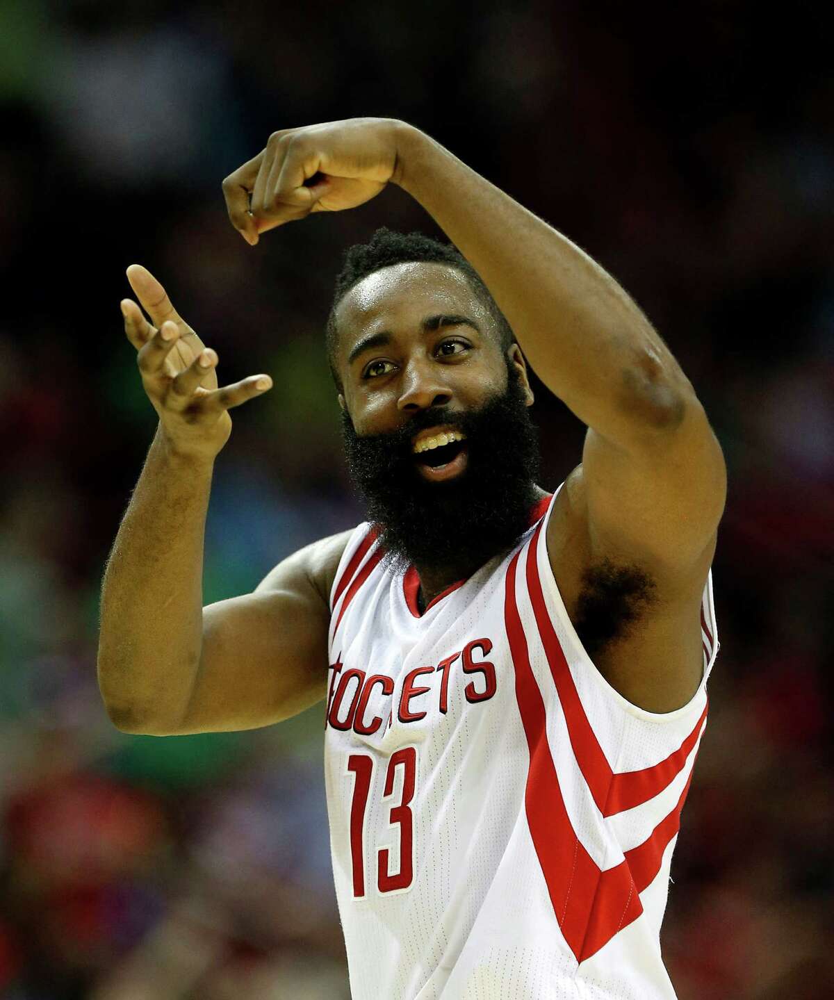 Houston Rockets guard James Harden (13) signals stirring the pot after his three-pointer during the second half of an NBA game at Toyota Center, Tuesday, March 17, 2015, in Houston. Rockets won 107-94.