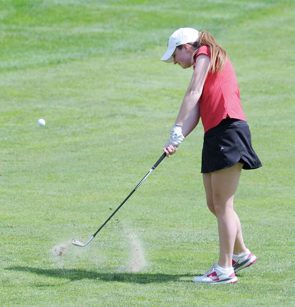Greenwich’s Catherine McEvoy plays onto the first green during the Cardinals’ match between against New Canaan Thursday at the Milbrook Club in Greenwich. McEvoy led Greenwich to a win with a 1-over-par 37 score.