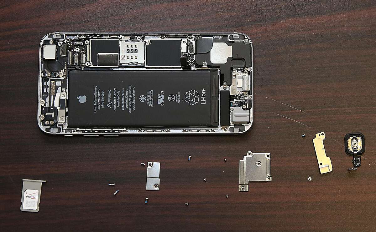 An iPhone is taken apart to fix a cracked screen.