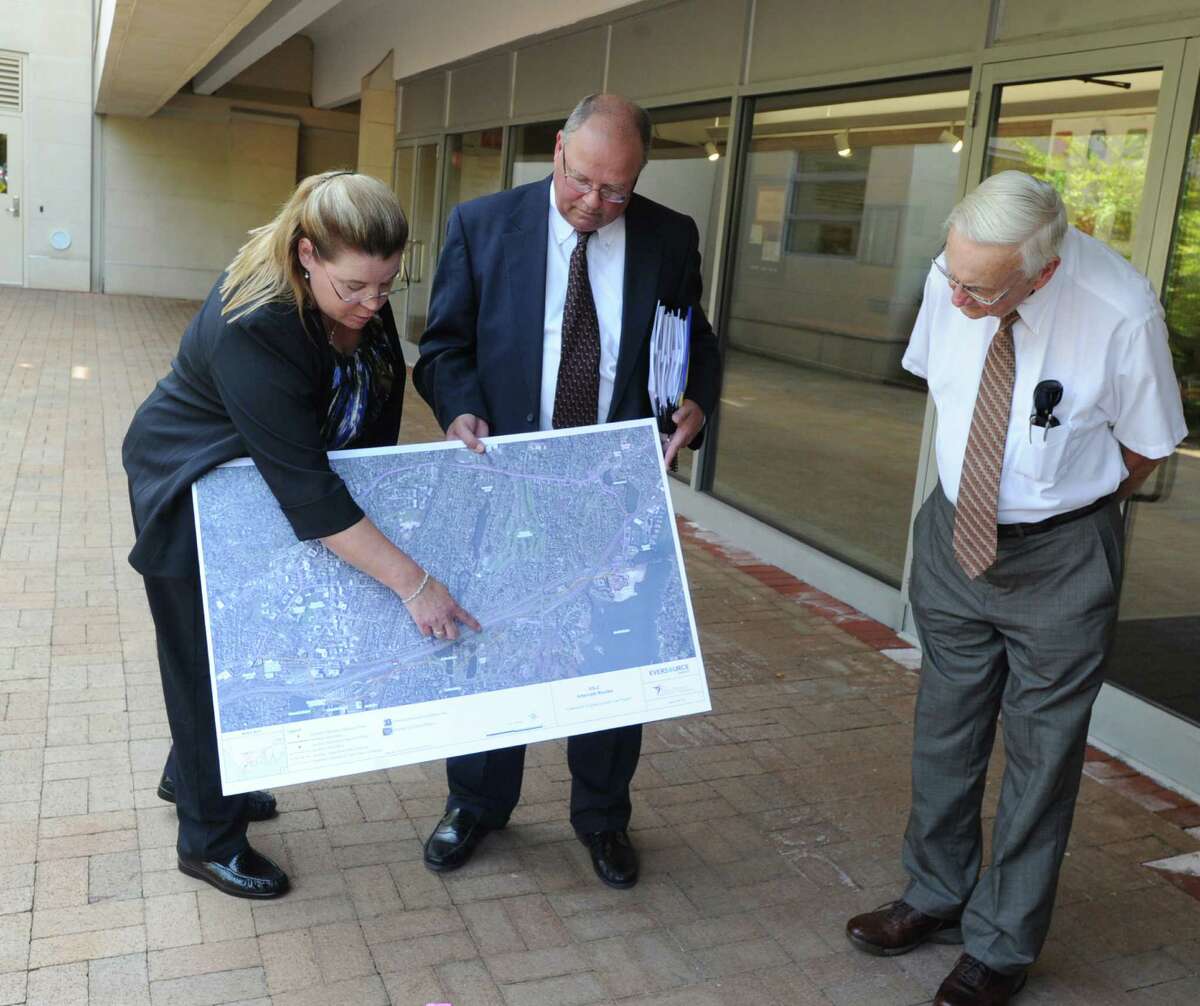 During a gathering at Greenwich Library, Jacqueline Gardell, left, of Eversource Energy, displays a map of Greenwich pointing out the proposed substation at 290 Railroad Ave., Greenwich, Conn., Tuesday, Sept. 1, 2015. Gardell was leading a siting council tour of the propsed substation. Members of the Connecticut Siting Council led that meeting and on Thursday decided to reject the Eversource proposal.