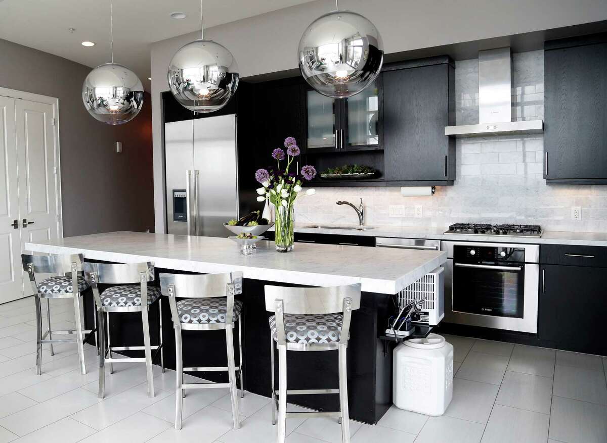 SILVER ACCENTS:  A modern aesthetic gives this kitchen a unique look.  See the rest of the home at houstonchronicle.com: Dentists downsized from West U traditional to penthouse posh
