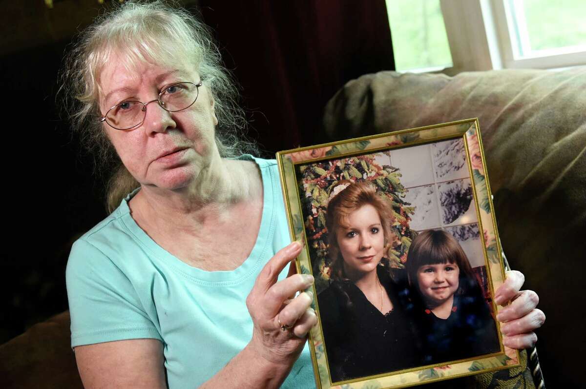 Shirley Olmsted holds a picture of her daughter, Audrey Herron, on Friday, May 13, 2016, in Hannacroix, N.Y. In this 1996 picture, Herron is with her daughter Sonsia Court, who was 4 years old at the time. Herron has been missing since 2002. (Cindy Schultz / Times Union)