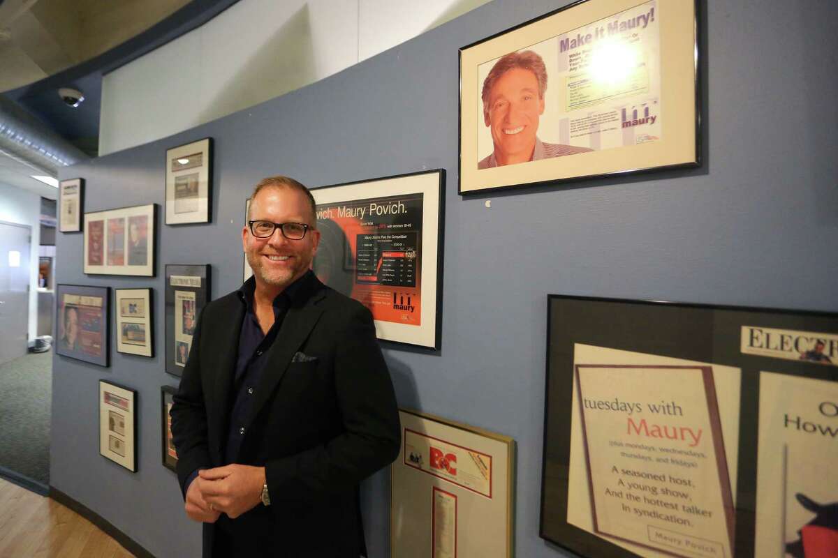 Paul Faulhaber, executive producer of the Maury show, poses in front of various articles and photos of Maury Povich inside the show’s Stamford office on Thursday. Faulhaber has been with the Maury show since day one and is celebrating the 3,000th episode of the show.
