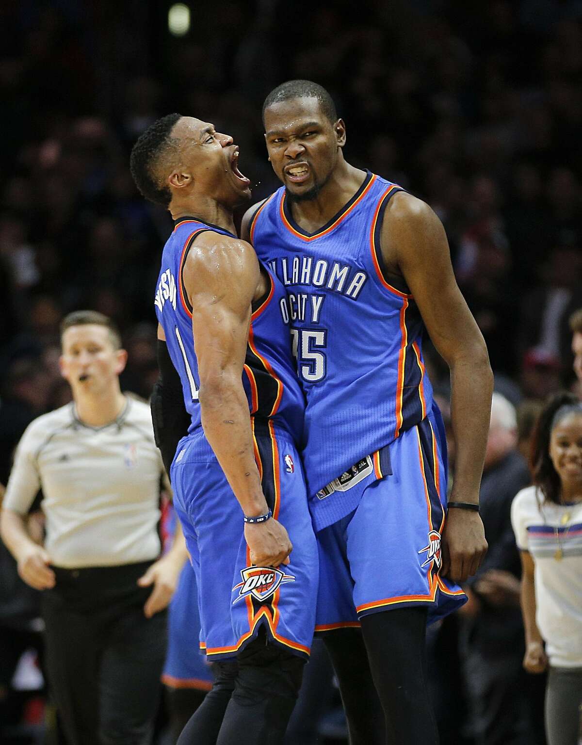 Oklahoma City Thunder's Kevin Durant, right, and Russell Westbrook celebrate their team's 100-99 win over the Los Angeles Clippers in an NBA basketball game, Monday, Dec. 21, 2015, in Los Angeles. (AP Photo/Jae C. Hong)