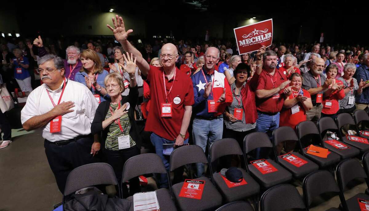 Delegates cheer after the national anthem Thursday at the Republican Party of Texas State Convention in Dallas. (Rodger Mallison / Fort Worth Star-Telegram)