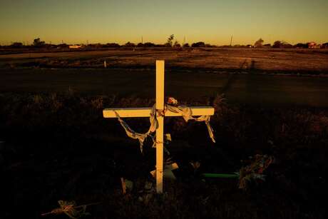 A memorial cross is planted in West near the spot where 15 people died, including a dozen firefighters who raced in unaware of the dangers at the plant.