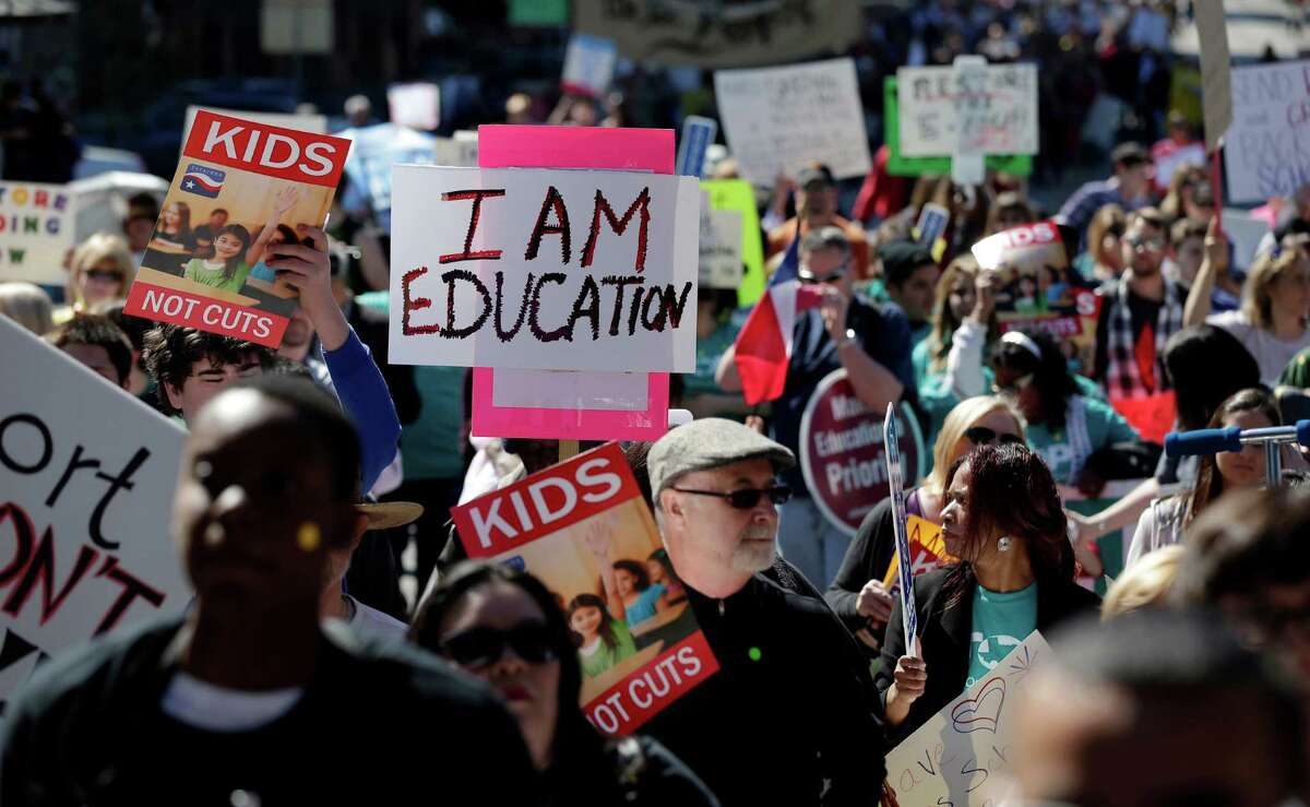 FILE - In this Feb. 23, 2013 file photo, teachers, students, parents and school administrators march up Congress Avenue to the state Capitol, in Austin, Texas to a rally for Texas public schools. The Texas Supreme Court has declared the state's school finance system constitutional - a surprise defeat for 600-plus school districts that sued. (AP Photo/Eric Gay, File)