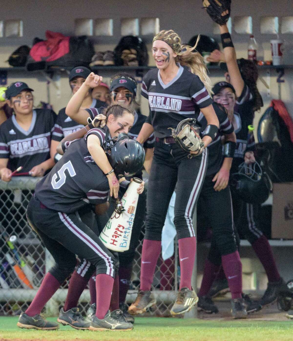 Lindsey Stewart (5) celebrates with her Pearland teammates after scoring in the second inning Friday.