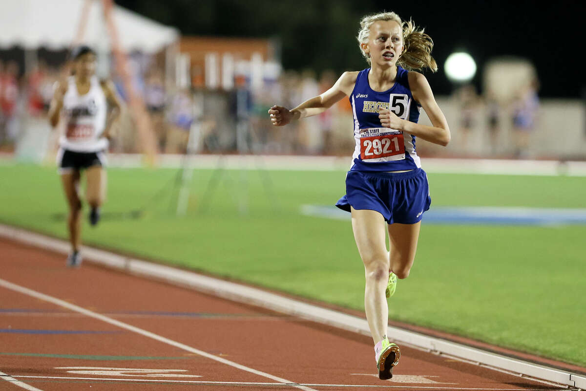 Alamo Heights’ Abby Gray looks to tie the stadium scoreboard as she crosses the finish line of the 5A girls 1,600-meter run during the second day of the UIL state track and field championships at Myers Stadium in Austin on May 13, 2016. Gray defended her state title in the event with a time of 4 minutes, 54.66 seconds.
