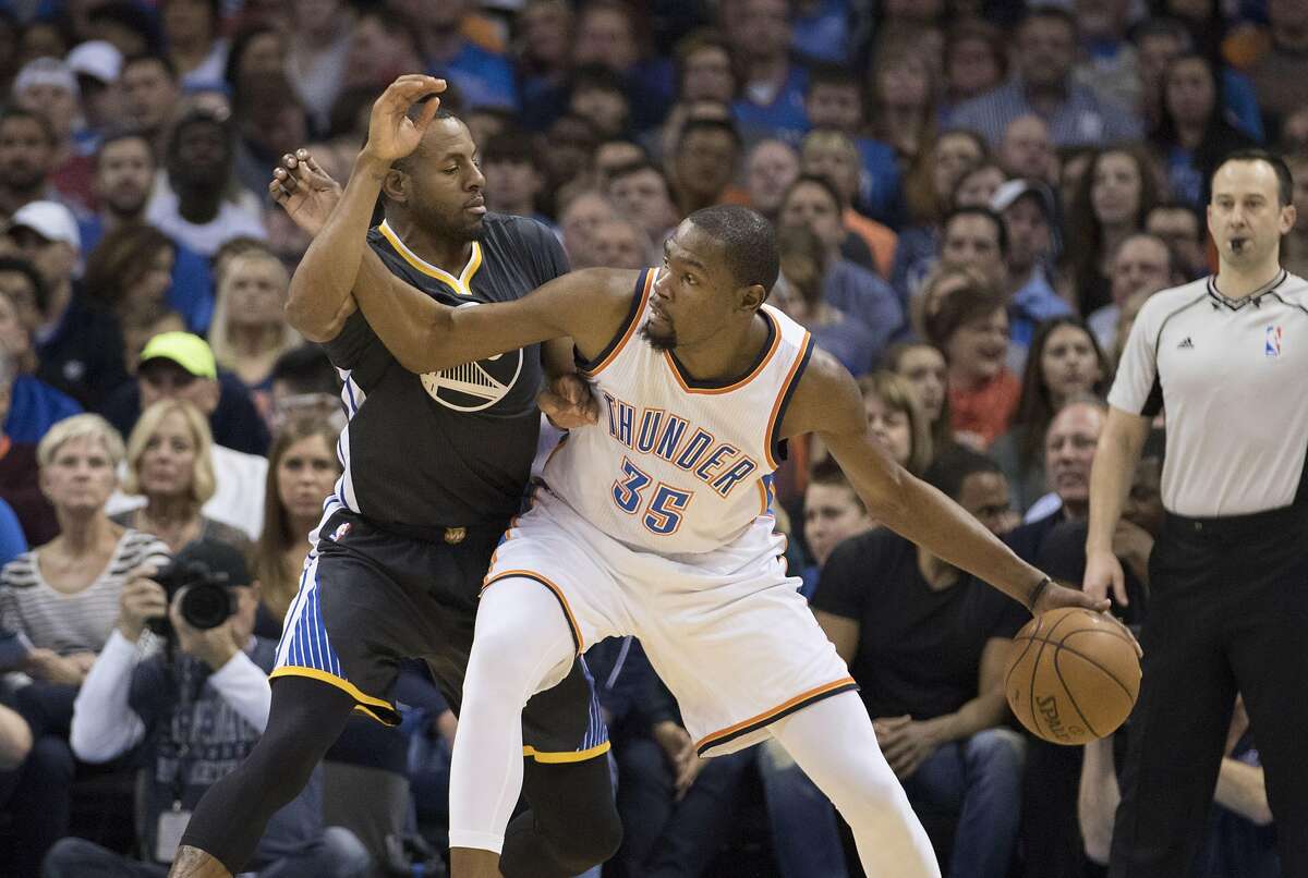 OKLAHOMA CITY, OK - FEBRUARY 27: Kevin Durant #35 of the Oklahoma City Thunder tries to drive around Andre Iguodala #9 of the Golden State Warriors as he looks for a play during the second quarter of a NBA game at the Chesapeake Energy Arena on February 27, 2016 in Oklahoma City, Oklahoma. NOTE TO USER: User expressly acknowledges and agrees that, by downloading and or using this photograph, User is consenting to the terms and conditions of the Getty Images License Agreement. (Photo by J Pat Carter/Getty Images)