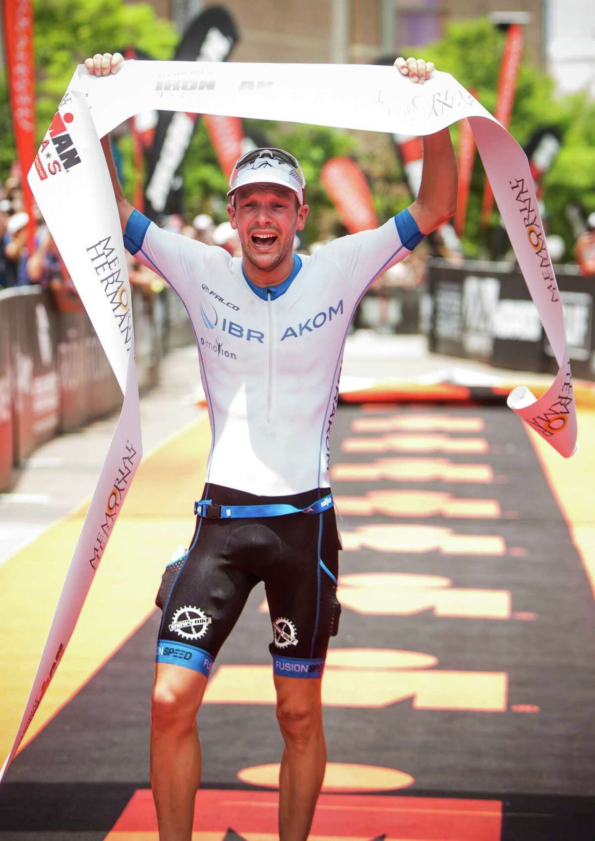 Patrick Lange, of Germany, crosses the finish line to win the Memorial Hermann Ironman North American Championship Texas triathon on Saturday, May 14, 2016, in The Woodlands.