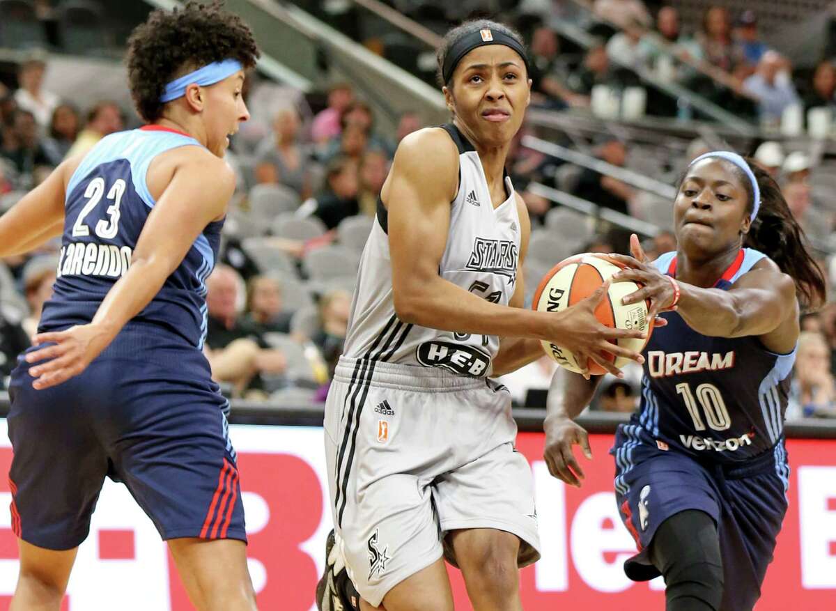 San Antonio Stars’ Sydney Colson looks for room between Atlanta Dream’s Layshia Clarendon (left) and Matee Ajavon during first half action on May 14, 2016 at the AT&T Center.