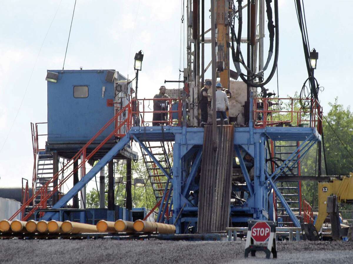 A crew works on a gas drilling rig at a well site for shale-based natural gas in Zelienople, Pa. Williams Cos. is following through on a promise to unload assets and double down in a region of the U.S. where natural gas production is still booming: the Marcellus Shale formation.