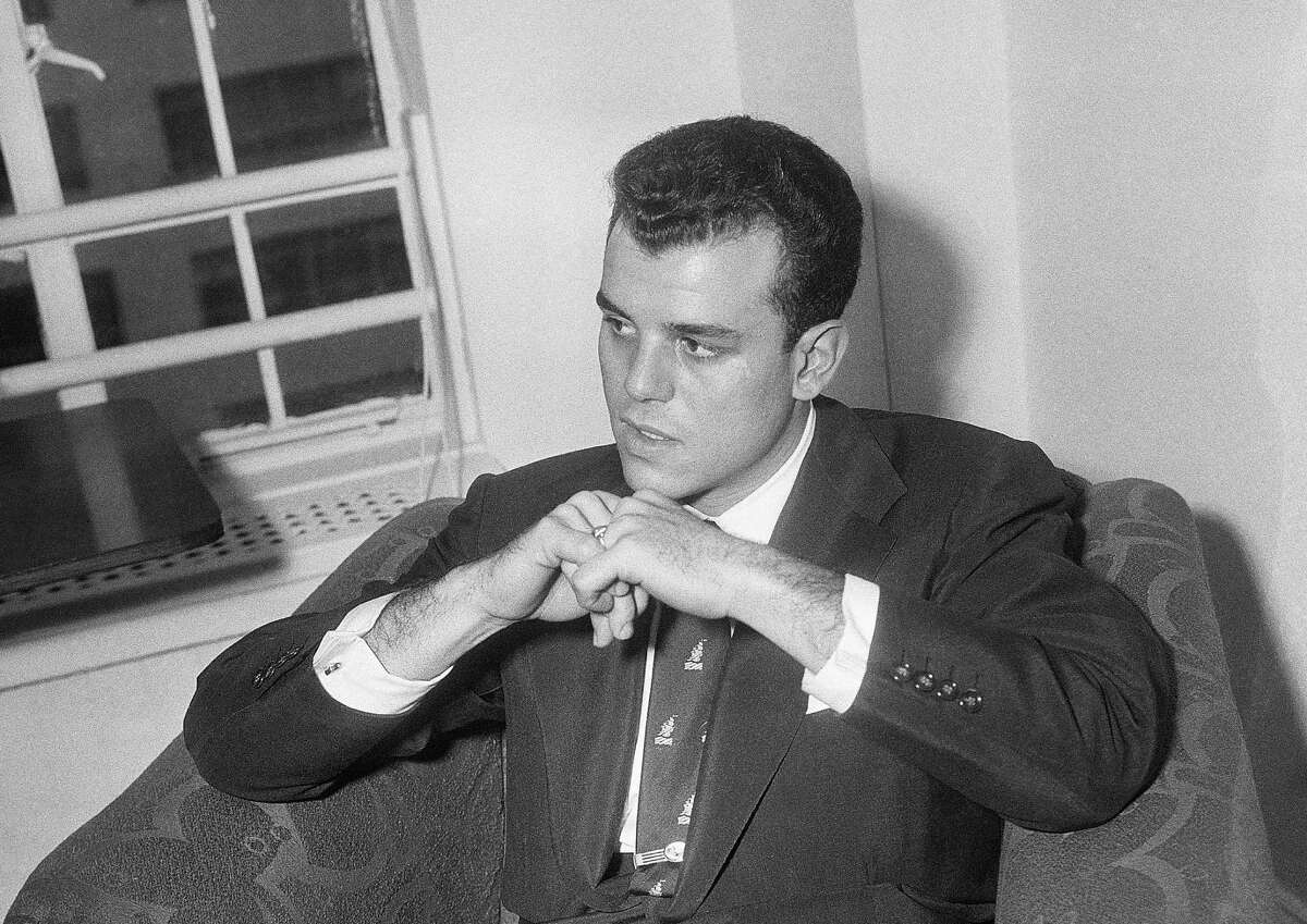 FILE - In this Oct. 26, 1953, file photo, Julius La Rosa, who was fired from the Arthur Godfrey shows, listens to a question during a news conference in Ed Sullivan's apartment in New York. La Rosa, a pop singer known for hits including "Eh, Cumpari," has died at age 86. (AP Photo/John Lindsay, File)