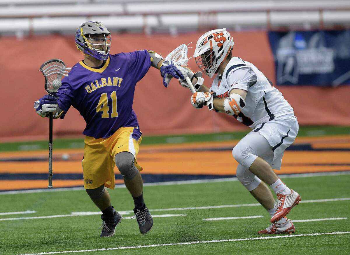 UAlbany's Eli Lasda move past Syracuse's Joe Gillis during the first round of Div. I Lacrosse NCAA playoffs, Sunday, May 15, 2016 in Syracuse, N.Y. (Jenn March/Special to the Times Union)