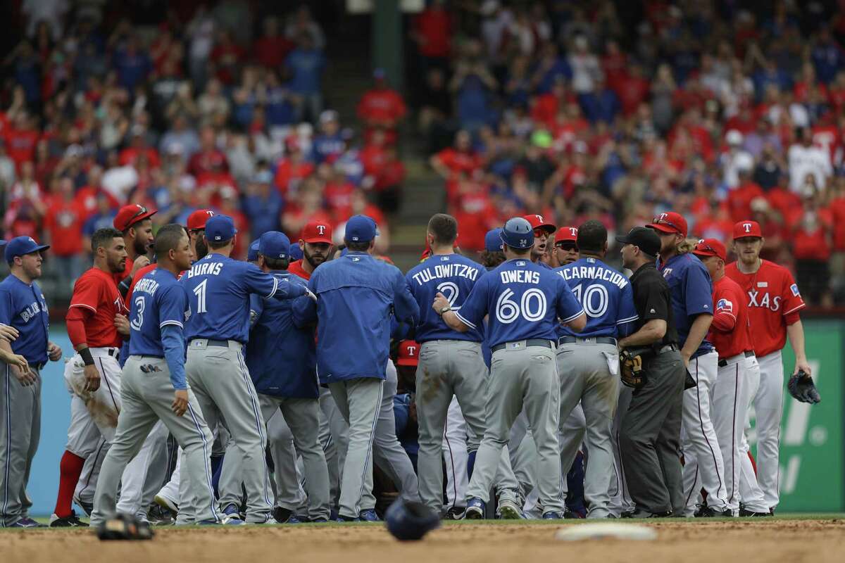 ARLINGTON, TX - MAY 15: The Toronto Blue Jays and the Texas Rangers clear the bench after Jose Bautista #19 of the Toronto Blue Jays was punched by Rougned Odor #12 of the Texas Rangers in the eighth inning at Globe Life Park in Arlington on May 15, 2016 in Arlington, Texas.
