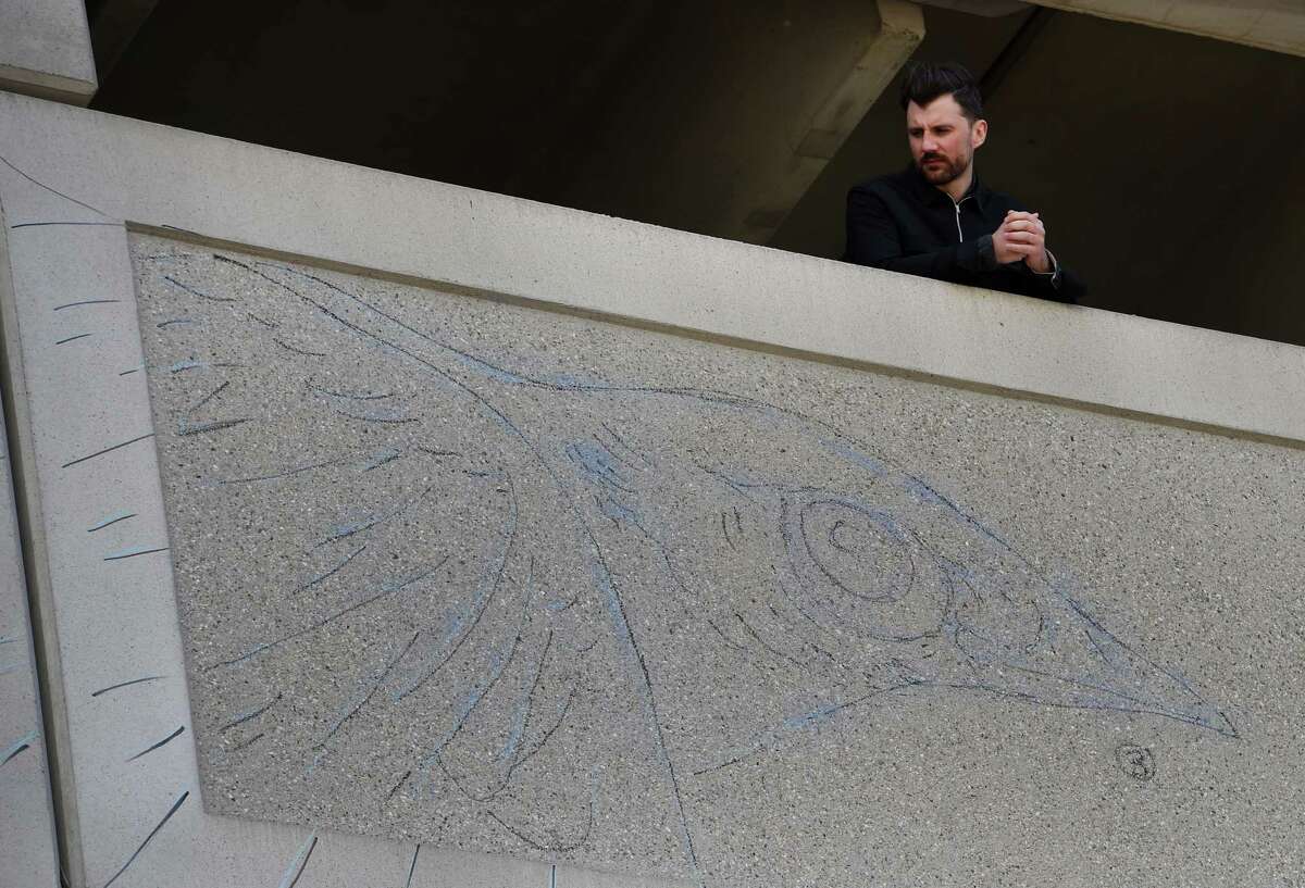 Artist Michael Conlin looks over the outline of his massive mural that will adorn the parking garage downtown near the Clinton Avenue exit of I 787 Monday May 16, 2016, in Albany, N.Y. The mural project is a collaborative effort of the Albany Parking Authority, Albany Center Gallery and Albany Barn as well as other downtown Albany organizations to "create a welcoming gateway into Downtown".(Skip Dickstein/Times Union)