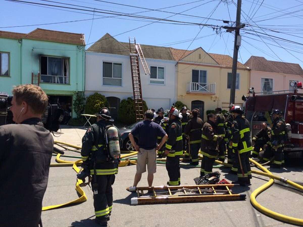 A firefighter and two residents were injured after two houses in San Francisco’s Outer Sunset caught fire Monday, May 16, 2016.
