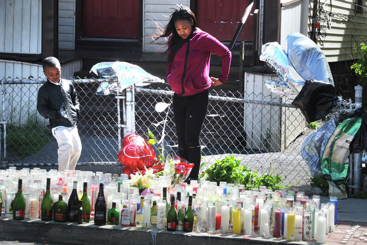 Visitors gather at a memorial set up near the spot on Madison Ave. where 18-year-old Kahlil Sloan-Diaz was shot a killed last Friday in Bridgeport, Conn., seen here May 16, 2016.