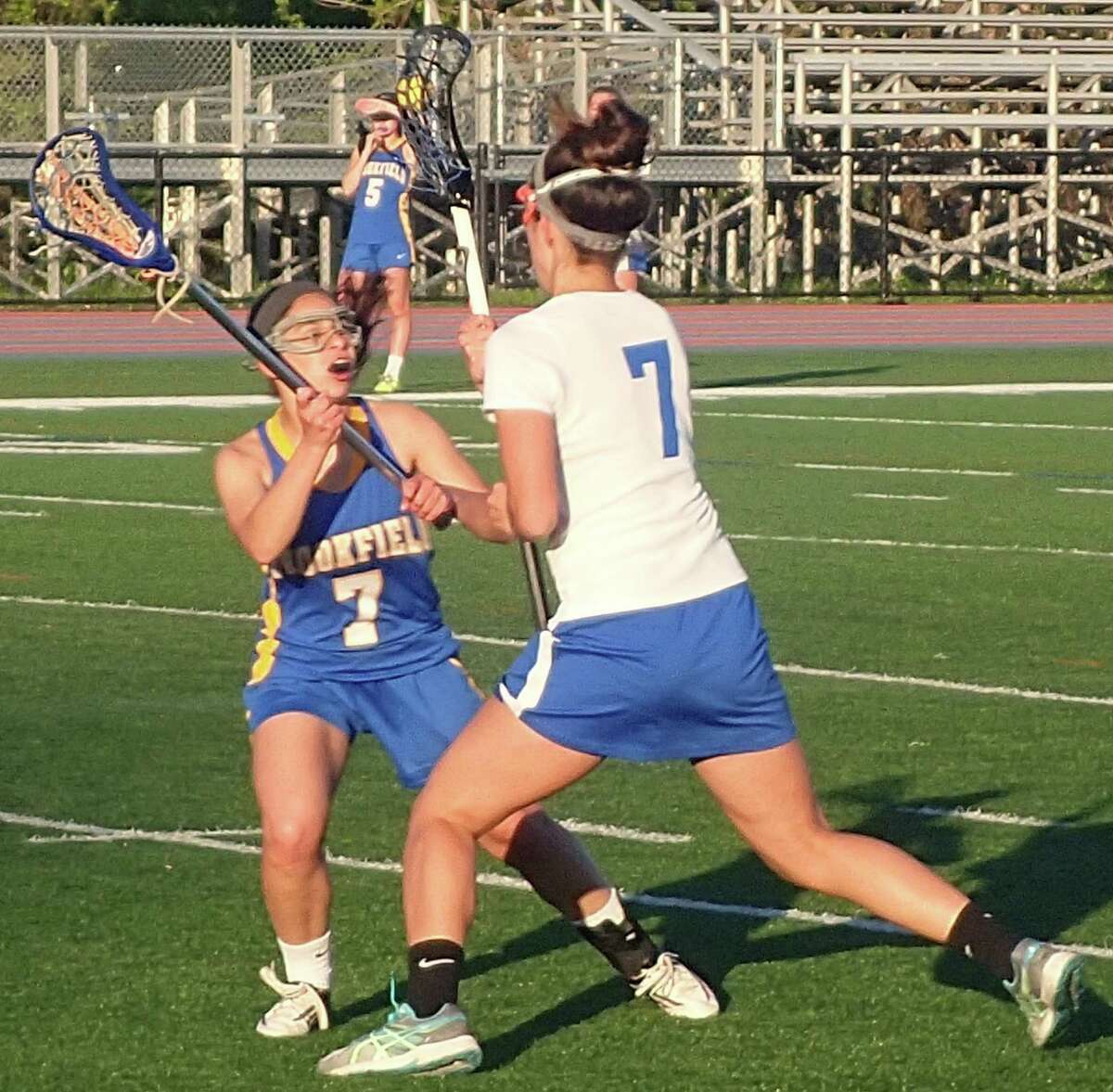 Danbury's Danielle Reisert, right, looks for room to maneuver as Brookfield's Julia Fernandez defends during their lacrosse game at Danbury High School May 16, 2016.