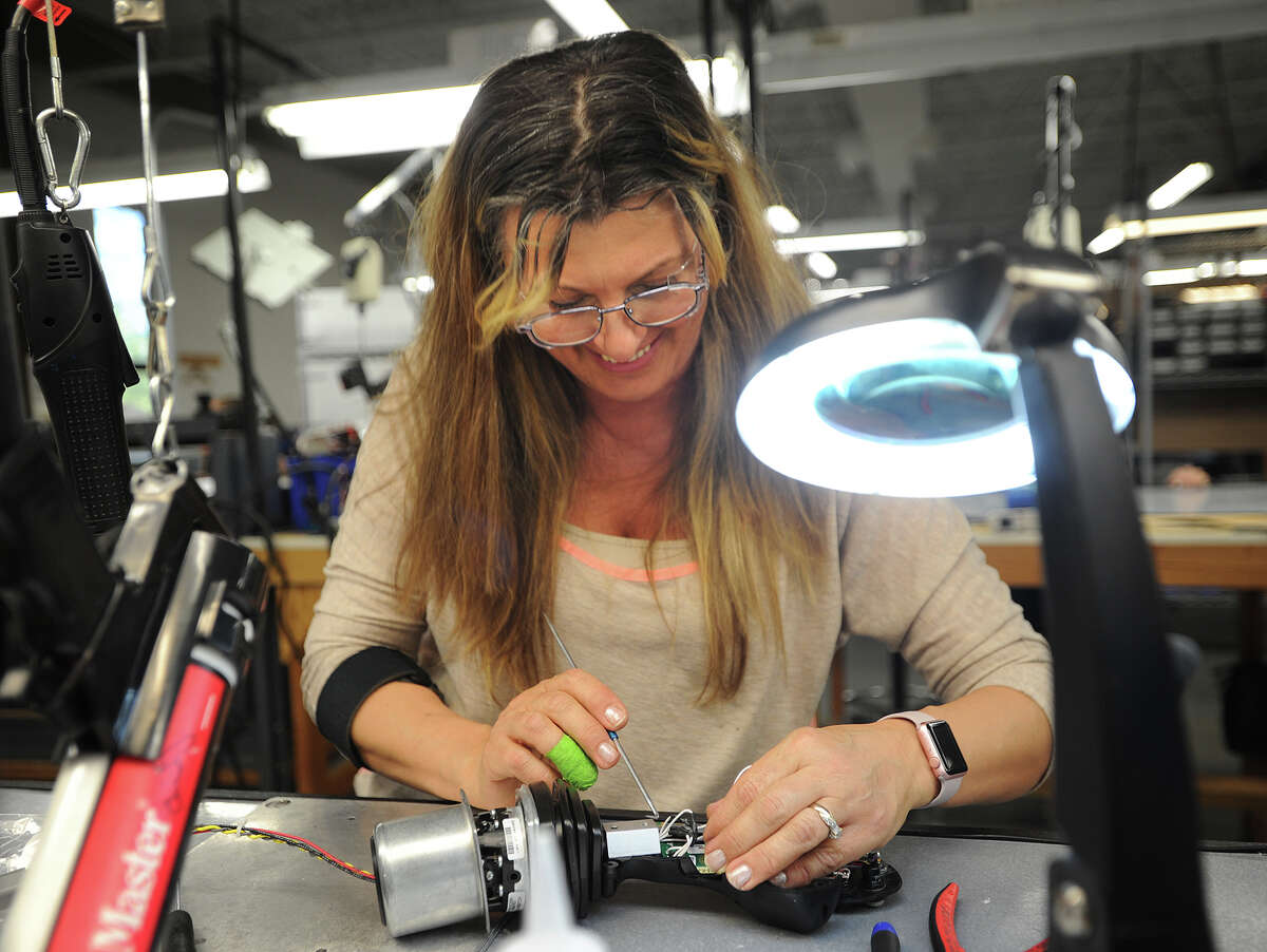 Sabira Mulaimovic, of Derby, assembles a controller for a garbage truck automated loader at OEM Controls, Inc. at 10 Controls Dive in Shelton, Conn. on Thursday, May 12, 2016. The company recently celebrated fifty years in business.
