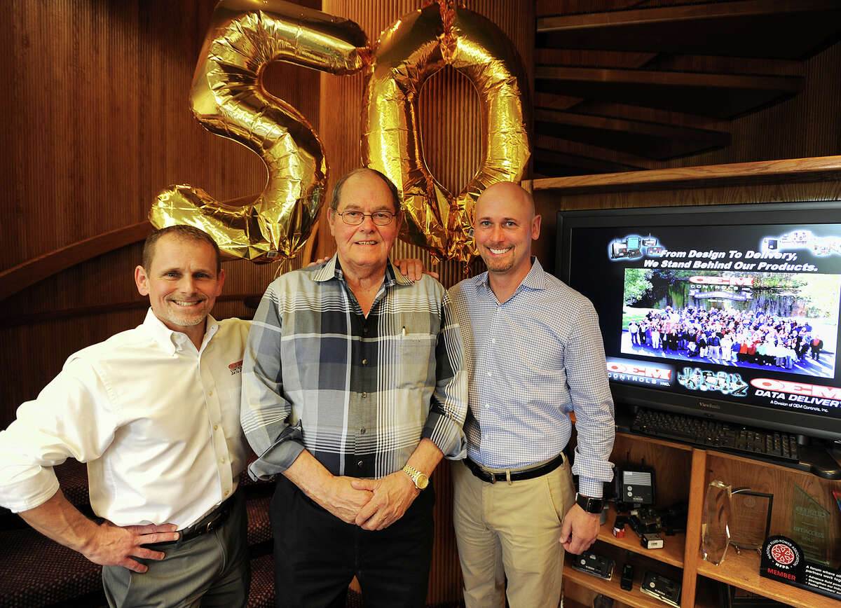 OEM Controls, Inc. CEO and founder Brian Simons, center, celebrates fifty years in business with his sons and company co-presidents Keith, left, and Sam Simons at the company at 10 Controls Dive in Shelton, Conn. on Thursday, May 12, 2016.