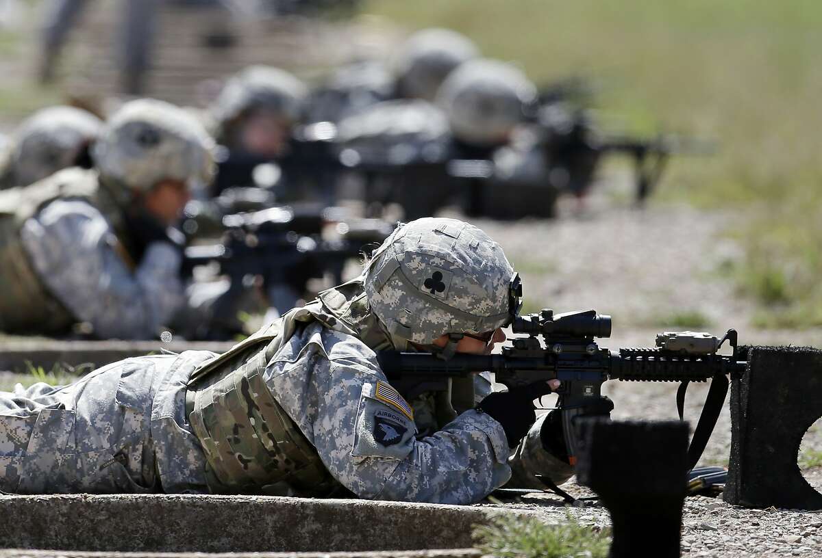 In this 2012 file photo, female soldiers from 1st Brigade Combat Team, 101st Airborne Division train on a firing range while testing new body armor in Fort Campbell, Ky.