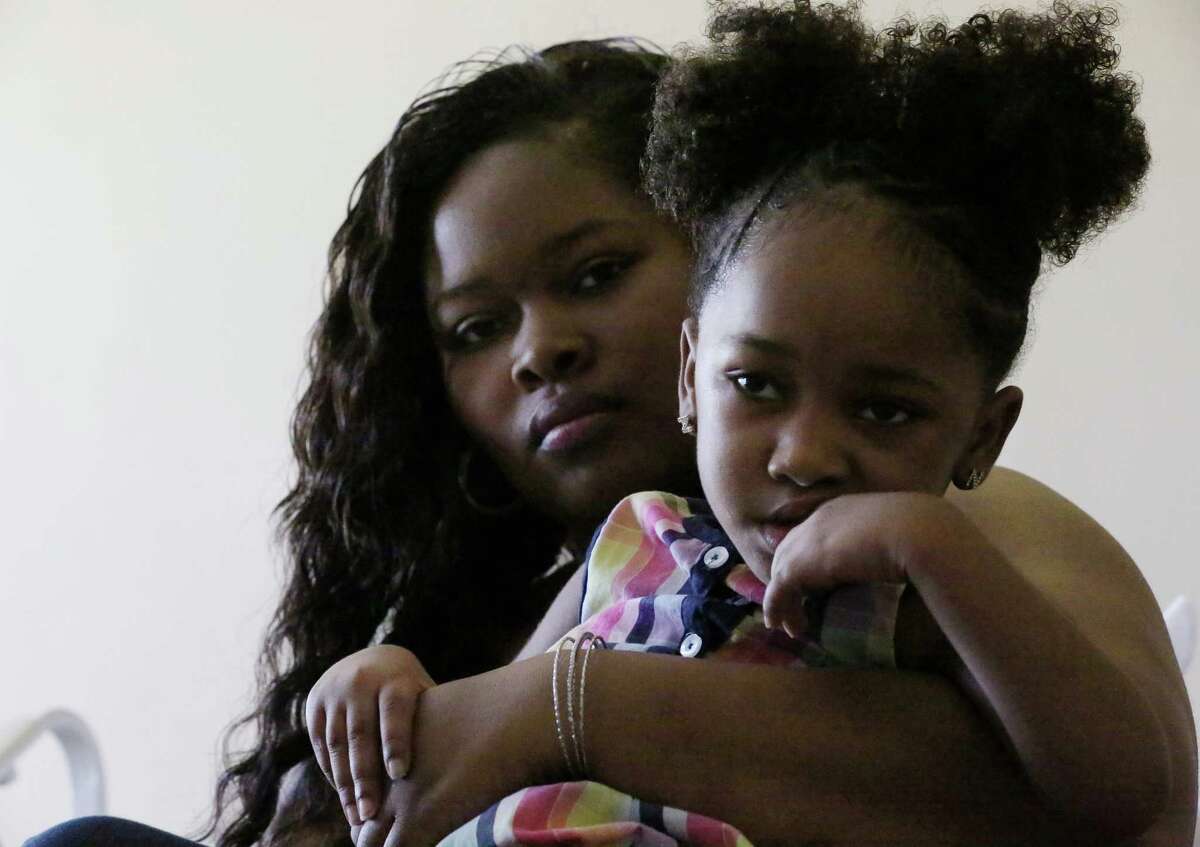 Courissa Hall, left, poses for a portrait with her daughter Nevaeh, 4, at a specialty and rehabilitation hospital in west Houston Thursday, April 7, 2016, in Houston. Nevaeh suffered brain damage during a dental procedure. Photo: Jon Shapley / Houston Chronicle )