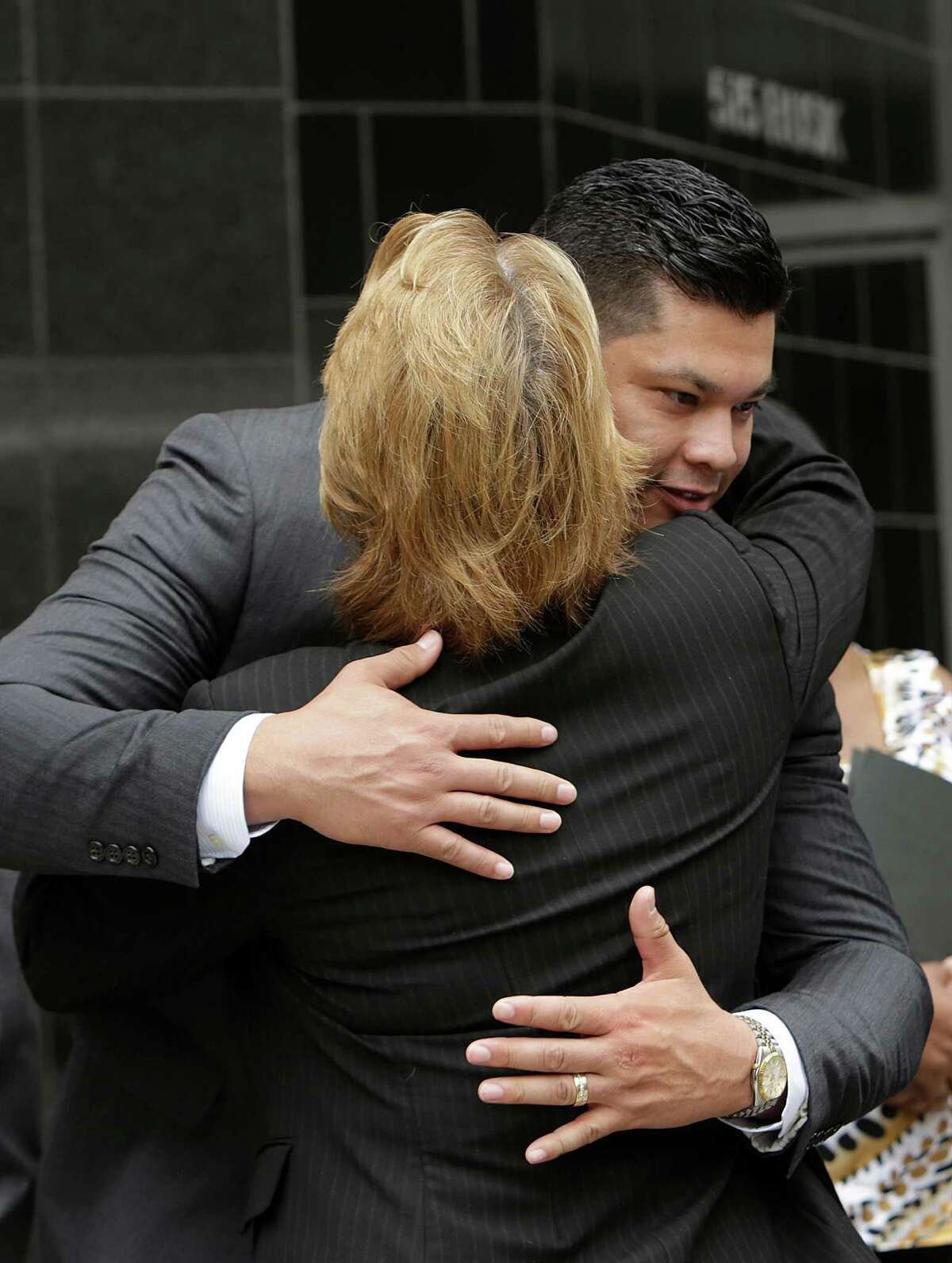 Attorney Kim Ogg hugs Christopher M. Zamora after announcing his legal victory on Tuesday.
