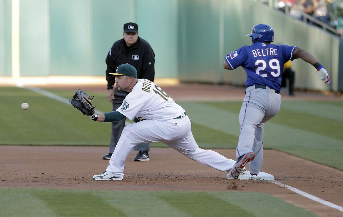 Billy Butler (16) waits for the throw from Marcus Semien (10) on a ball hit by Adrian Beltre (29) in the first inning as the Oakland Athletics played the Texas Rangers at the Oakland Coliseum in Oakland, Calif., on Tuesday, May 17, 2016.