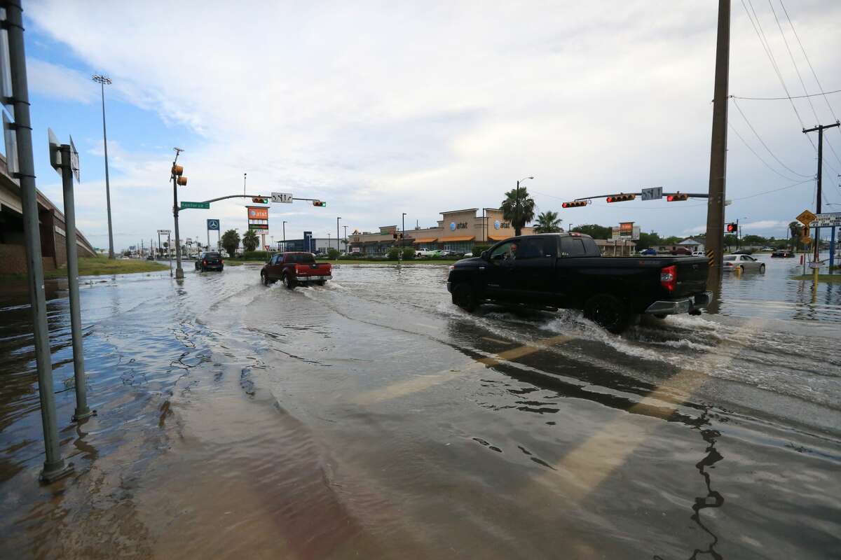 Vehicles pass through the intersection of South Padre Island Drive and Kostoryz Road on Monday, May 16 in Corpus Christi. Thunderstorms in South Texas that dumped up to a foot of rain have led to flood-related rescues in Corpus Christi and sewage spilled into a creek.