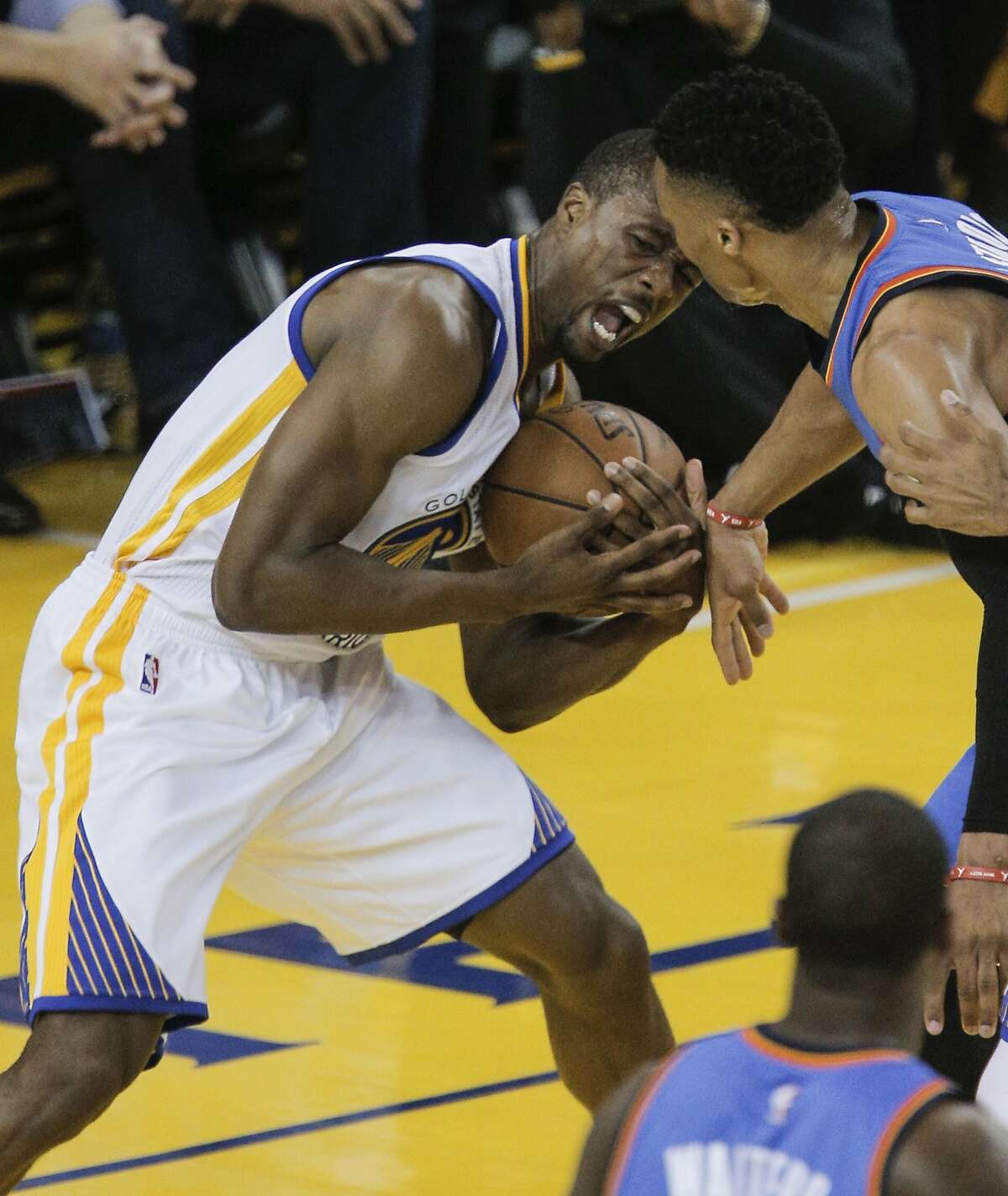 Golden State Warriors� Harrison Barnes fights Oklahoma City Thunders� Russell Westbrook for a rebound in the first quarter during Game 2 of the NBA Western Conference Finals at Oracle Arena on Wednesday, May 18, 2016 in Oakland, Calif.
