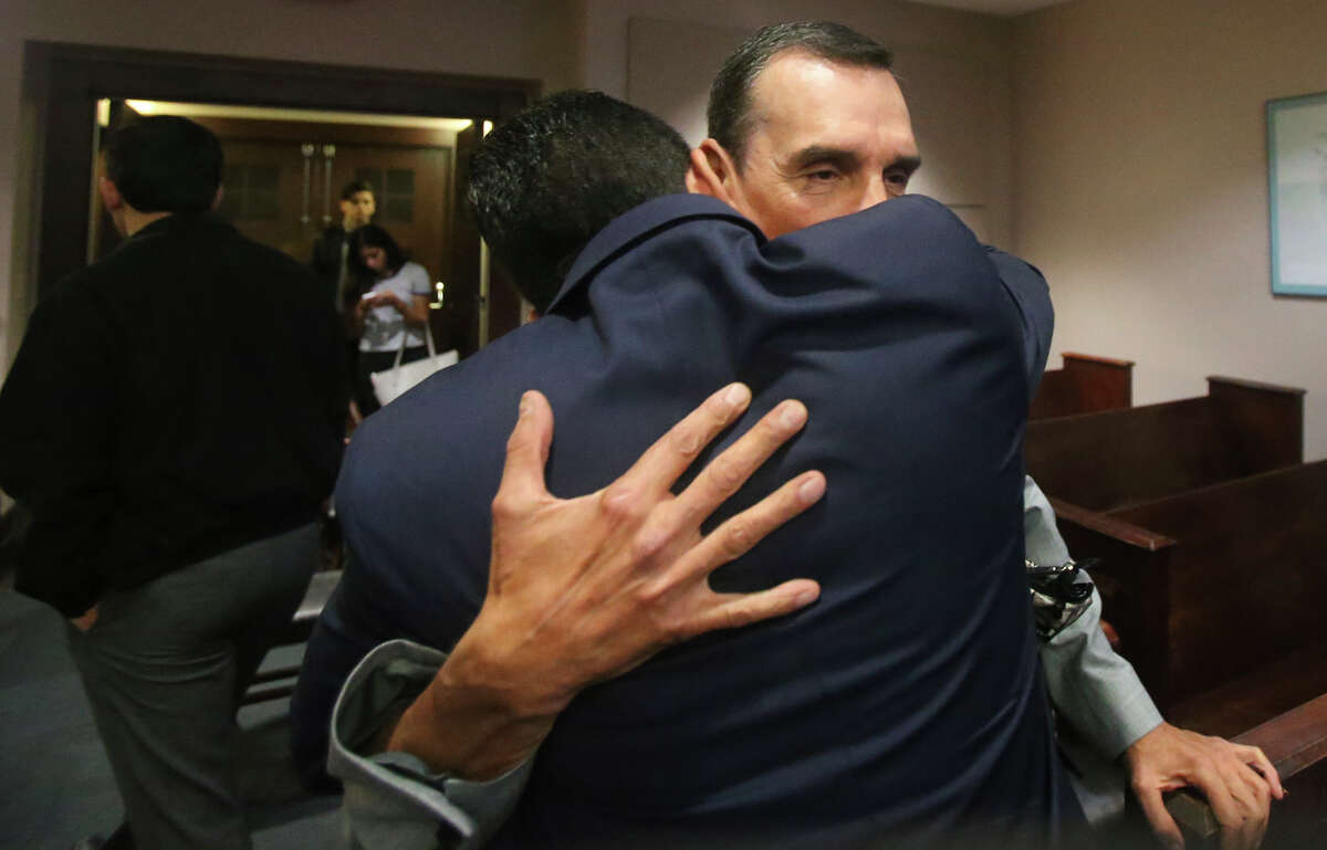 Ricardo Flores (facing) hugs his son Antonio Flores (facing away) Wednesday May 18, 2016 during the manslaughter trial of Antonio Flores, now 22, in the 226th District Court. Georgina Rodriguez, 16, died in a 2013 car accident in which Flores was believed to be racing. Another girl, Gabriella Lerma,17, also died in the crash.