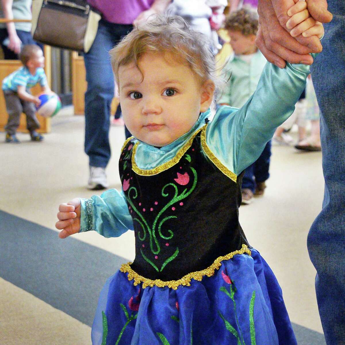 One-year-old Alyssa McVoy of Delmar joins the parade through the Bethlehem Public Library as it hosts a Preschool Prom at the library Thursday May 19, 2016 in Delmar, NY. (John Carl D'Annibale / Times Union)