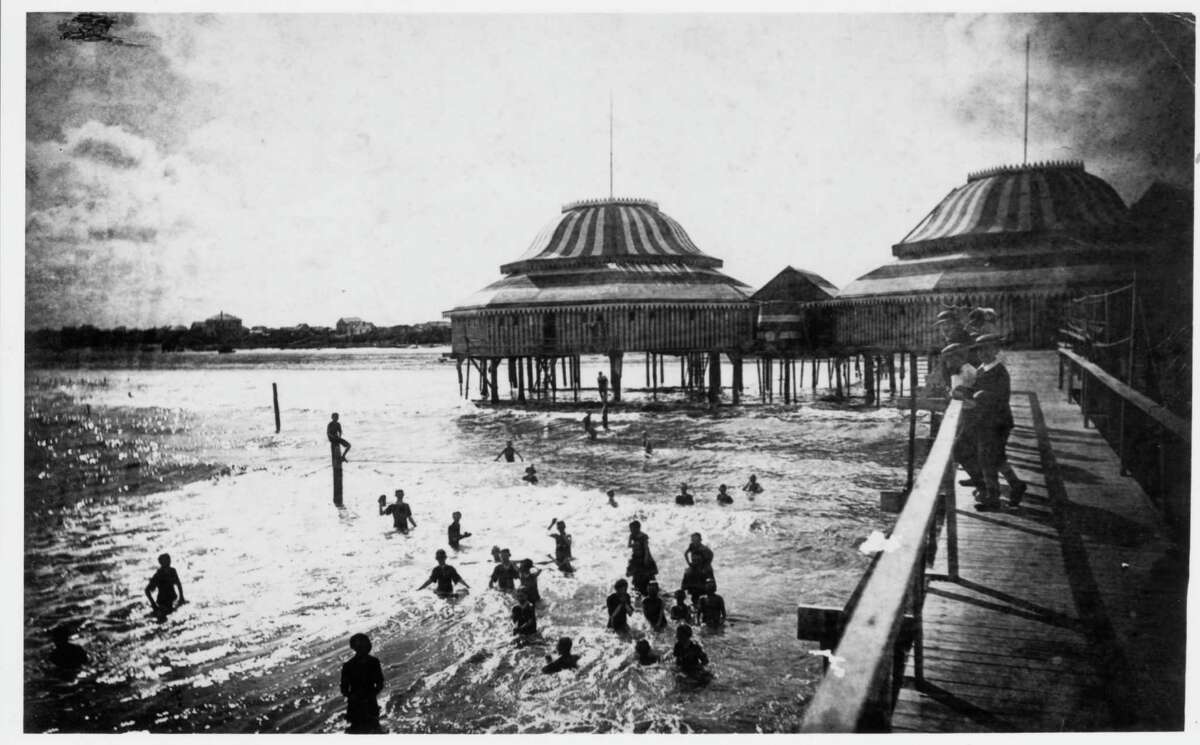 1900: Galvestonians enjoy the beach and surf at The Pagoda, described as 'a building extending out into the sea on a piling, with a long walk.' Islanders watched the sea from the walkway for the last time on Sept. 8, 1900 when a hurricane of 100-plus miles per hour and towering tidal waves destroyed or damaged most of the city, killing thousands. The Pagoda was not rebuilt.